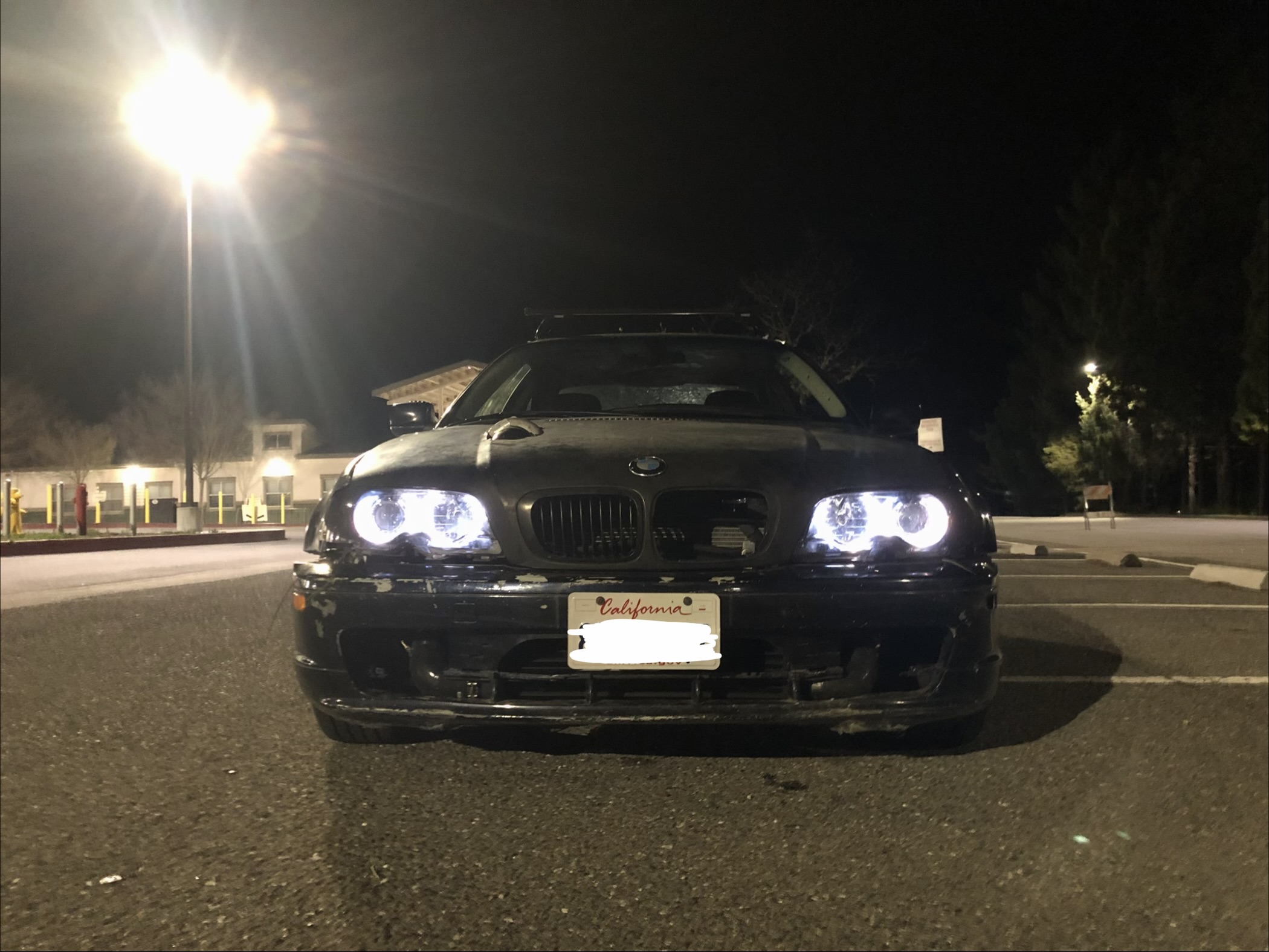 Turbocharged BMW E46 325ci with angel-eye headlights at night